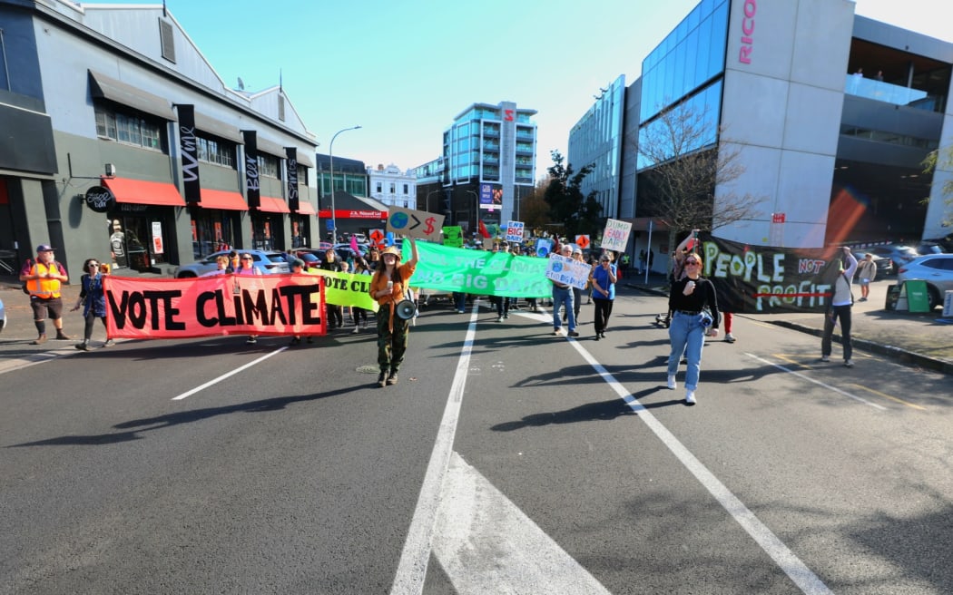 Climate advocates take part on a march in Auckland on 26 May, 2023, demanding New Zealand reduces its emissions, transition to regenerative agriculture, lower the voting age to 16 and respond to the climate crisis with tangata whenua at the center of decision making.