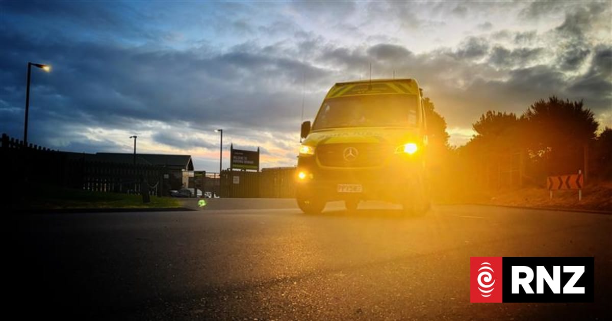 A yellow Mercedes-Benz truck driving on a road at sunrise or sunset.