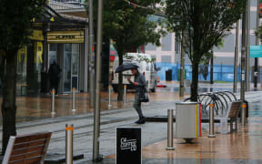 A commuter in the Christchurch CBD after heavy rain.