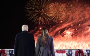 US President-elect Donald Trump and his wife Melania Trump watch fireworks during a reception in his honor at Trump National Golf Club Washington DC in Sterling, Virginia, on January 18, 2025. (Photo by Alex Brandon / POOL / AFP)