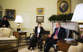 US President George W. Bush (R) speaks to the press during a meeting with New Zealand Prime Minister Helen Clark 21 March 2007 in the Oval Office.