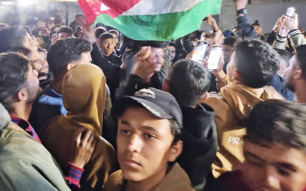 Local people celebrate the announcement of the cease-fire agreement in Gaza, State of Palestine on 15 January, 2025. A young man waves the Palestinian flag to express his rejoice. ( The Yomiuri Shimbun ) (Photo by YOMIURI SHIMBUN / Yomiuri / The Yomiuri Shimbun via AFP)