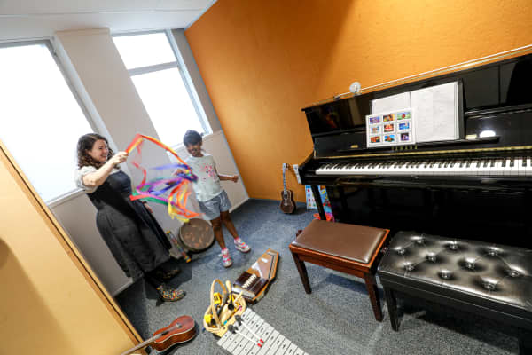 Six-year-old Kiara enjoys played with colourful ribbons at Raukatauri Music Therapy Centre in Auckland, alongside her music therapist Aliss Pollock.