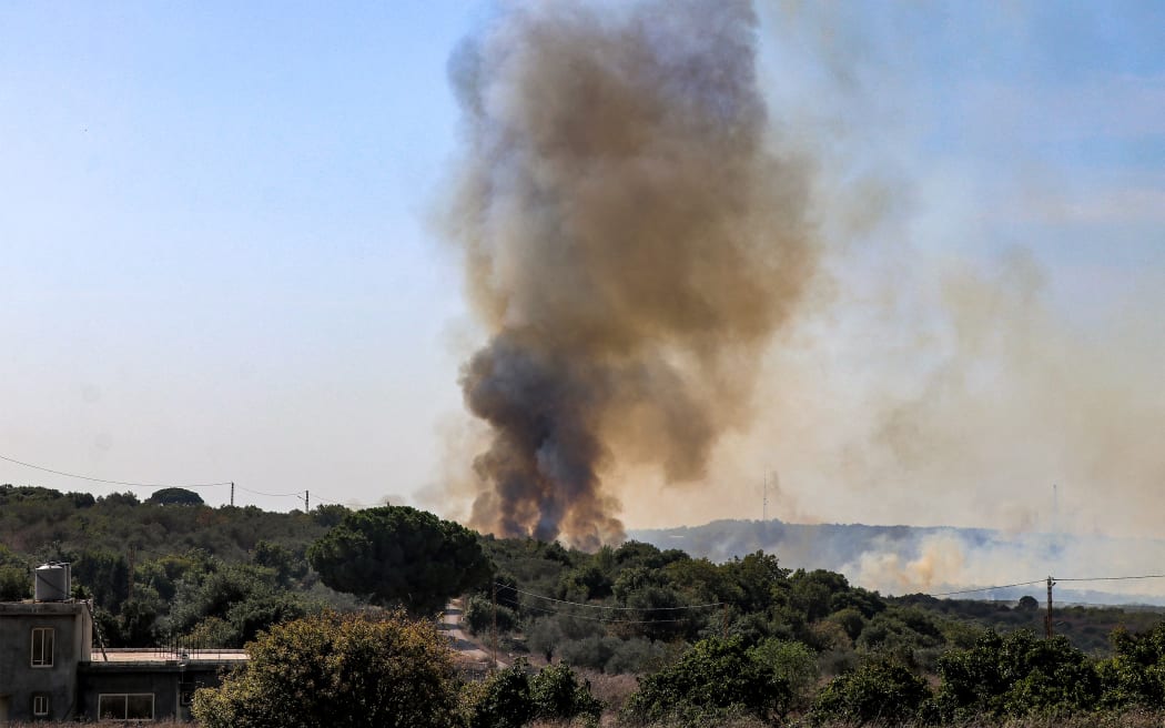 A smoke plume rises during a forest fire that reportedly ignited after shell fire from Israel, in the Labouneh area in southern Lebanon close to the border with northern Israel, on October 26, 2023, amid the ongoing battles between Israel and the Palestinian group Hamas in the Gaza Strip.