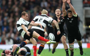 New Zealand All Blacks Scott Barrett  tries to block down Barbarians Andy Ellis