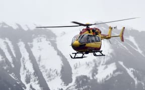 A helicopter participates in rescue efforts in the southeastern French town of Seyne.