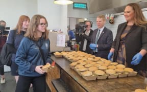 Chris Hipkins and Carmel Sepuloni serve up burgers at Waitara High School.
