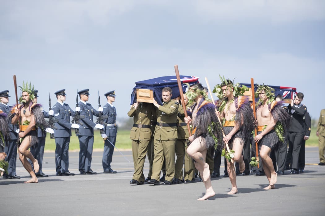 The he taua (war party) leads the caskets towards the awaiting families of the two soldiers.