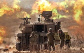 An Israeli army self-propelled howitzer fires rounds near the border with Gaza in southern Israel on October 11, 2023. Israel declared war on Hamas on October 8 following a shock land, air, and sea assault by the Gaza-based militant group. The death toll in Israel has surged above 1,200 following the worst attack in the country's 75-year history, while Gaza officials have reported 1000 people killed so far. (Photo by JACK GUEZ / AFP)