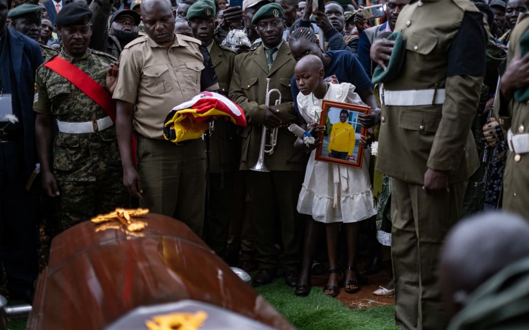 Charity Chebeti eight,  the youngest daughter of Rebecca Cheptegei, reacts during the burial of her mother in  Bukwo on September 14, 2024. Olympian Rebecca Cheptegei, died after her partner set her on fire in Kenya and succumbed to severe burns the week after being attacked by Kenyan Dickson Ndiema Marangach. (Photo by Badru KATUMBA / AFP)