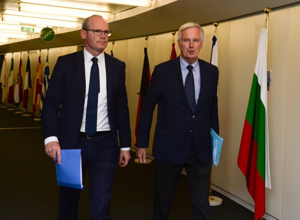 Irish Foreign Minister Simon Coveney (left) arrives to meet with European Union's chief Brexit negotiator Michel Barnier at the EU Commission headquarters in Brussels yesterday.