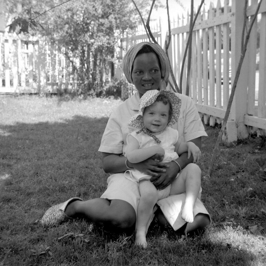 Margaret, Marshal Walker's maid in South Africa, holding one of Marshall's daughters.