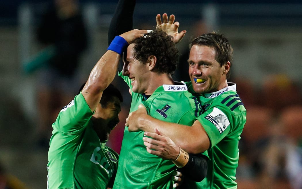The Highlanders fullback and captain Ben Smith celebrates a try with his team-mates.