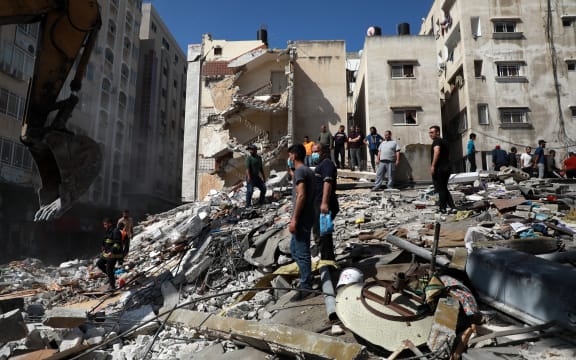 Palestinians inspect a destroyed house, after it was struck by Israeli strikes, in Gaza City this week.