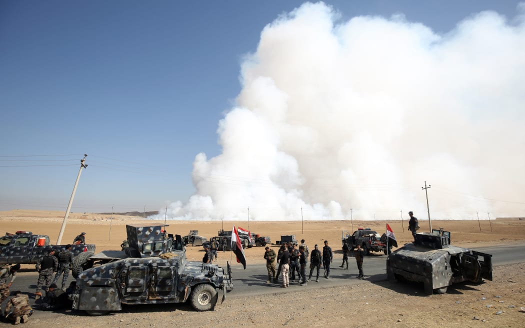 Smoke billows from a sulphur factory, set alight by IS militants, about 30km south of Mosul.