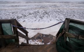 Waves break onto a stairway along the footpath along Main Beach located on the Gold Coast on 8 March.