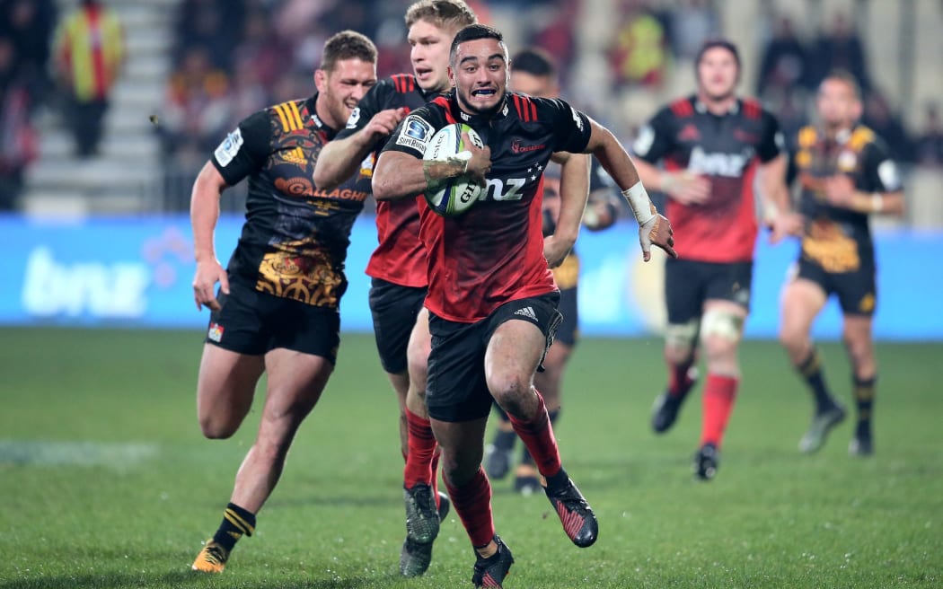 Bryn Hall of the Crusaders runs in to score his try.