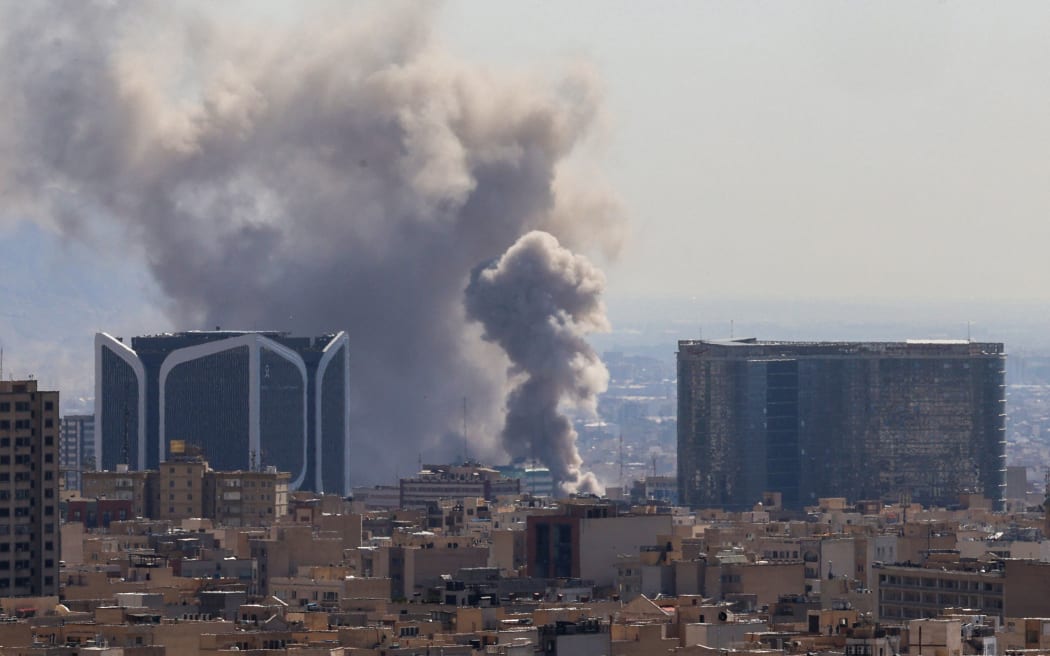 Plumes of smoke rise following reported explosions in Tehran on 1 March.