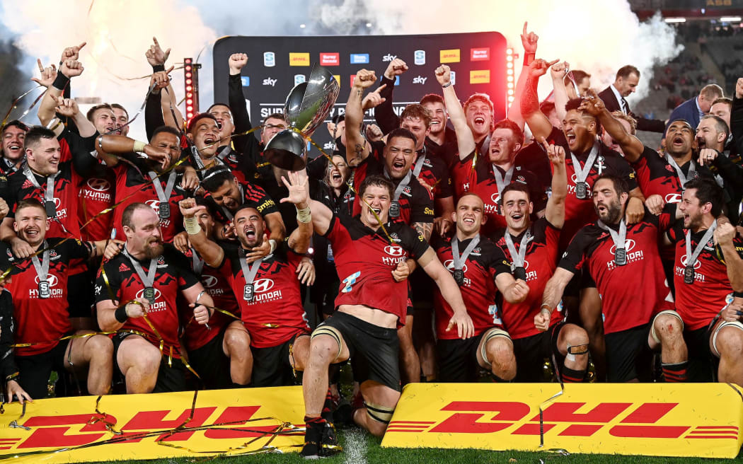 Crusaders captain Scott Barrett raises the trophy with the Crusaders team to celebrate winning the final.