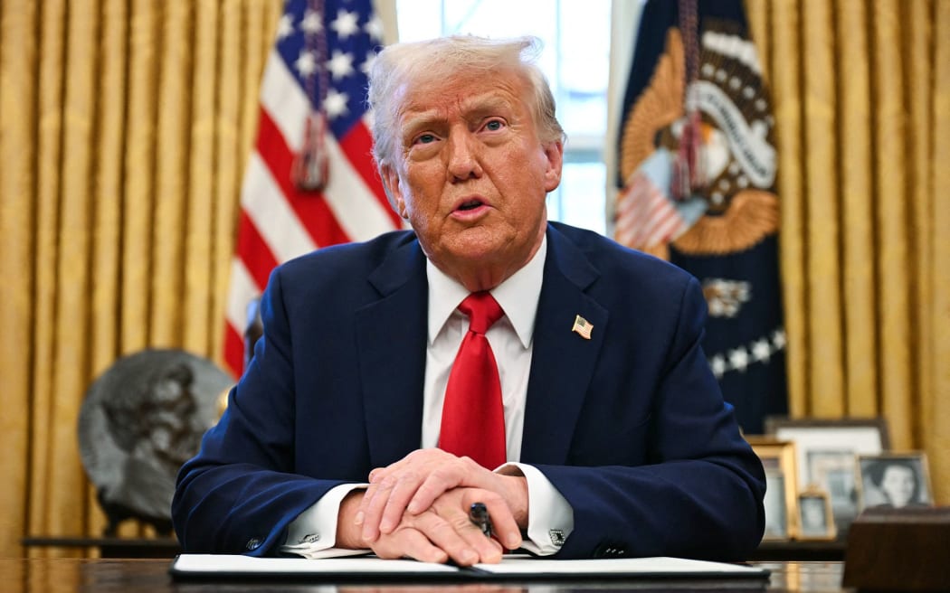 US President Donald Trump speaks to the press in the Oval Office at the White House.