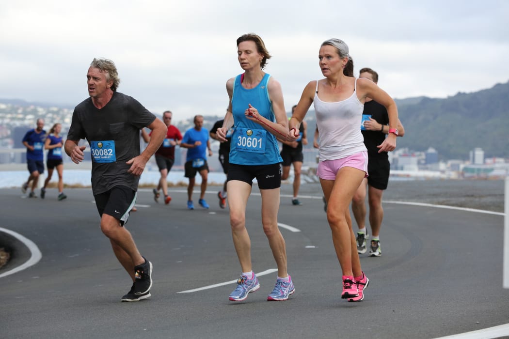 Melissa Moon guiding blind runner, Maria Williams during a round the bays race in Wellington