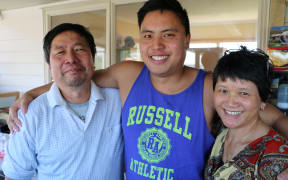 Isaiah Tour and his parents Huat and Amanda.