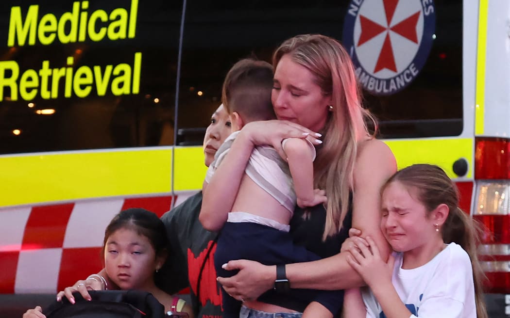 A family leaves the Westfield Bondi Junction shopping mall after a stabbing incident in Sydney on April 13, 2024. Australian police on April 13 said they had received reports that "multiple people" were stabbed at a busy shopping centre in Sydney. (Photo by David GRAY / AFP)