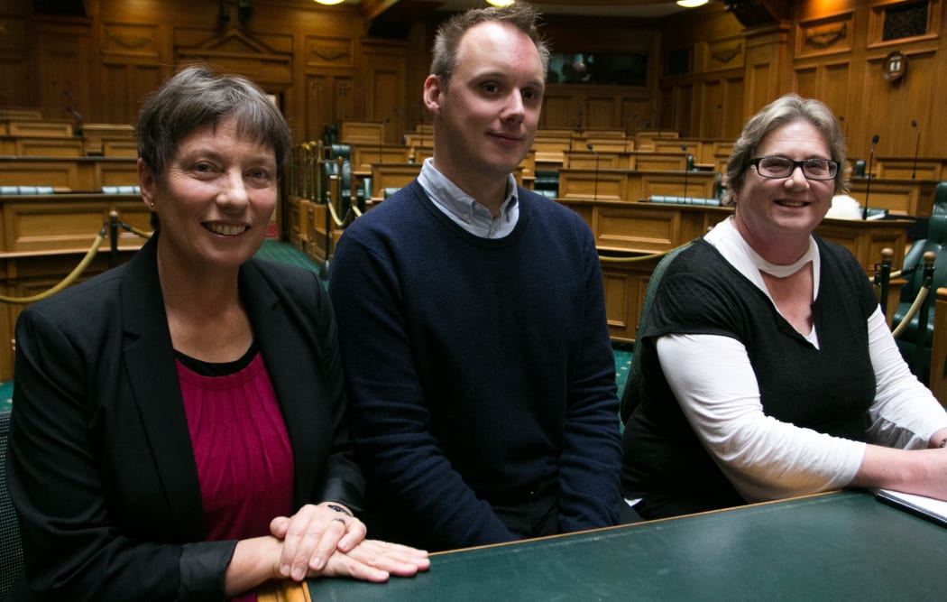 Hansard's Cecilia Edwards (left), Luke Harris (centre) and Sue Langdon (right) sit at the Hansard reporting table in the middle of the debating chamber.