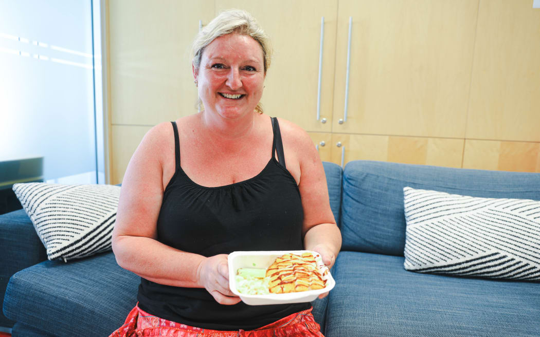 Lunch with Crunch founder Claire Kelly holding a chicken katsu dish her company has provided to schools