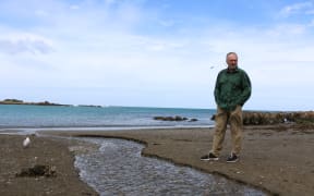 Eugene Doyle at the outlet at Ōwhiro Bay that, in recent months, has measured 30 times the level of fecal contamination considered safe to swim.