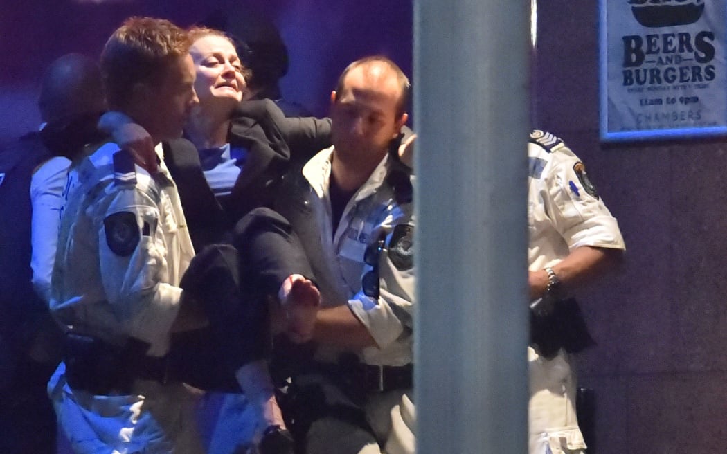 An injured hostage is carried out of the Lindt Chocolate Cafe in Sydney's Martin Place