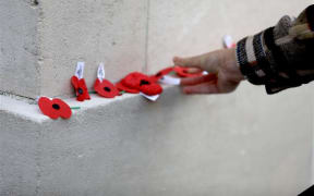 People laying poppies at Auckland War Memorial Museum on Anzac Day 25 April 2025.