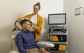 Dr Nicholas Hoeh and Kate Godfrey demonstrating rTMS