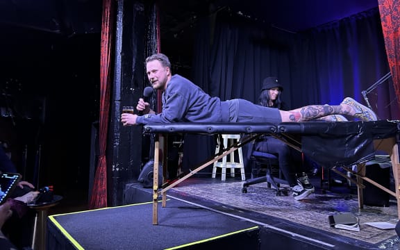 Ivan Fadjukoff mid-performance, mid-tattoo.