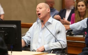 Russell Tully shouts over the judge in court.