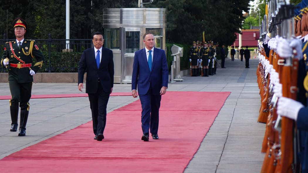 Prime Minister John Key walks up the red carpet as he is officially welcomed by Premier Li Keqiang at the Great Hall of the People, Beijing.