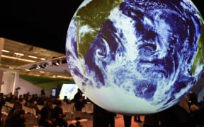 People visit the American display at COP21, the United Nations conference on climate change at Le Bourget.