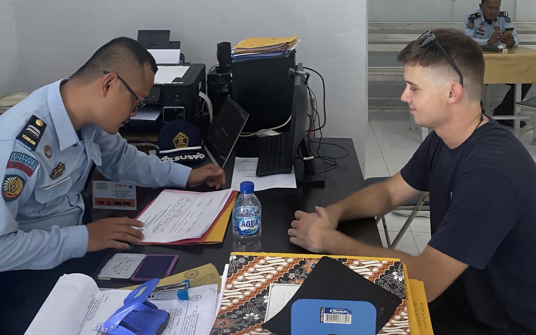 This handout picture taken and released on June 6, 2023 by the Aceh Ministry of Justice and Human Rights regional office shows Australian citizen Bodhi Mani Risby-Jones (R) attending his release at the Sinabang prison in Simeuleu on 6 June 2023, after reconciling with the victim of his rampage last April while he was drunk, and paid a compensation fee of over 16,000 USD. (Photo by Handout / Aceh Ministry of Justice and Hum / AFP) / RESTRICTED TO EDITORIAL USE - MANDATORY CREDIT "AFP PHOTO / Aceh Ministry of Justice and Human Rights regional office" - NO MARKETING NO ADVERTISING CAMPAIGNS - DISTRIBUTED AS A SERVICE TO CLIENTS