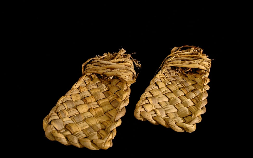 A pair of sandals found in a dry cave in Southland. The laces were tied around the foot and ankle.