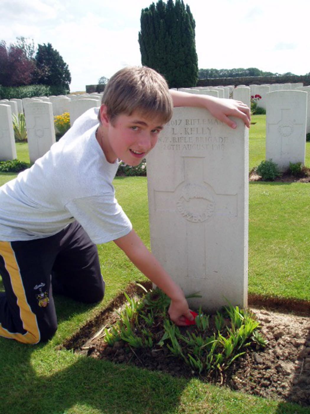 A photo showing Robert Kelly, aged 16, at his great-great uncle's grave at Vaulx Hill Cemetery in France, June 2007