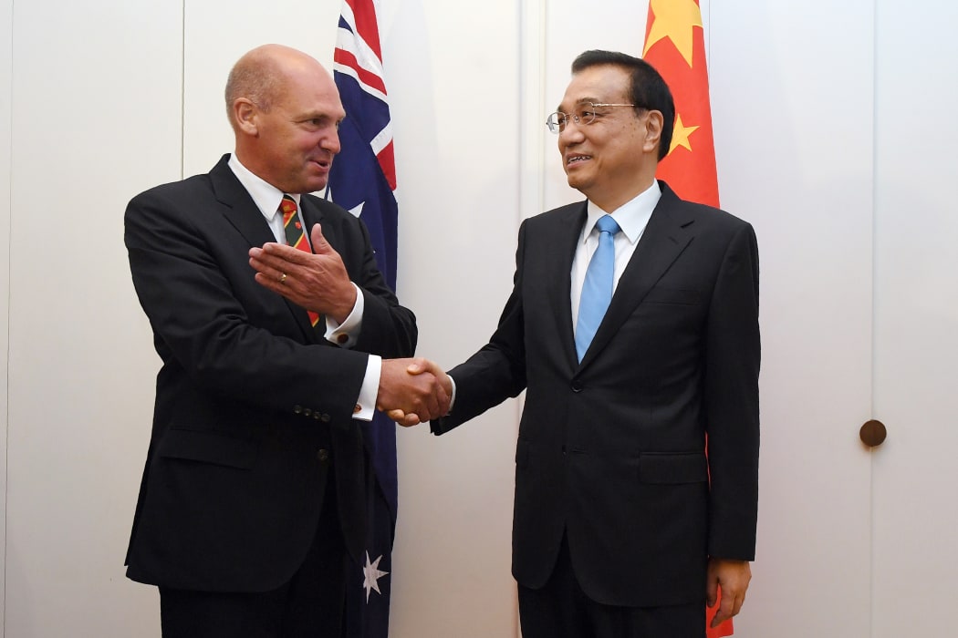 China's Premier Li Keqiang shakes hands the President of the Senate Stephen Parry (L) at Government House in Canberra on March 23, 2017.