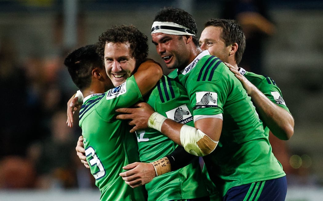 Marty Banks is swamped by his Highlanders team-mates after kicking the match-winning penalty