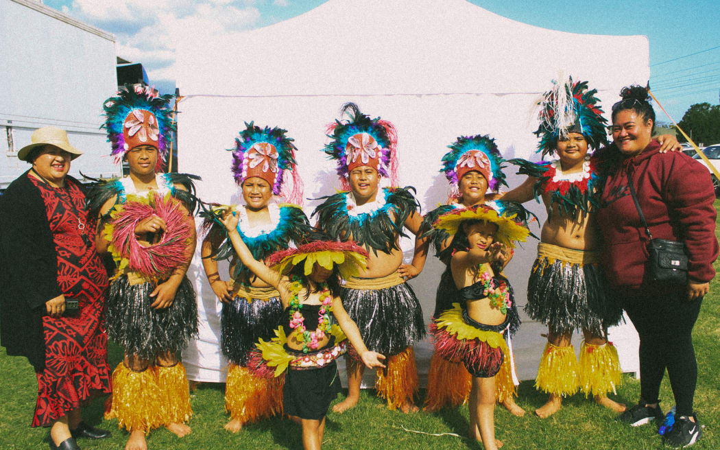 Young performers pose backstage with family.