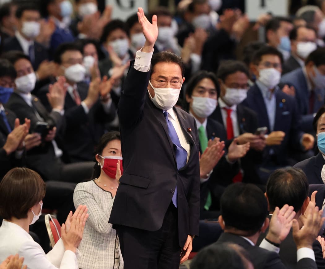 Japan's new Prime Minister Fumio Kishida celebrates after winning  Liberal Democratic Party (LDP) vote.