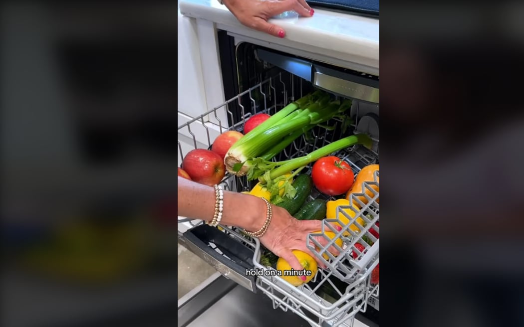 Screenshot from video on TikTok of person washing fruit and vegetables in dishwasher.
