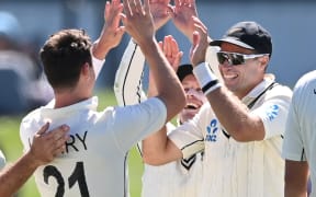 Matt Henry, Henry Nicholls and Tim Southee celebrate the wicket of Kagiso Rabada during play on day one of the first cricket test between South Africa and New Zealand at Hagley Oval in Christchurch, New Zealand.