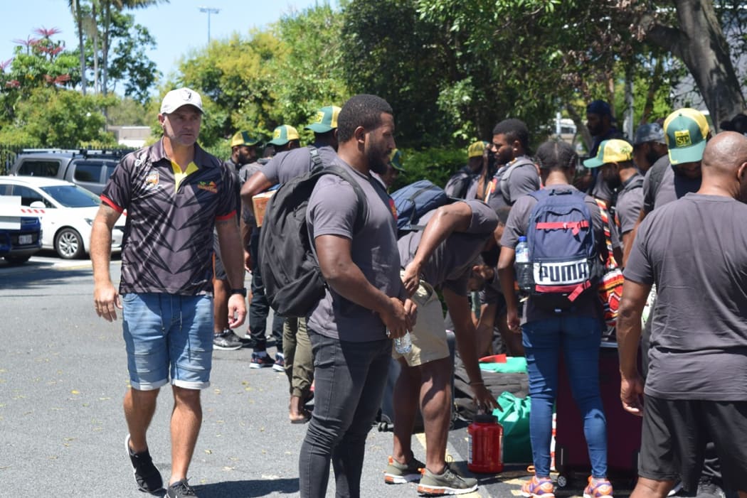 PNG Hunters Matt Church (L) watches on as players unpack their gear on the Gold Coast.