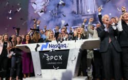 Bret Johnsen (C), SpaceX Chief Financial Officer, and Gwynne Shotwell (center R), SpaceX President and Chief Operating Officer, celebrate with SpaceX employees as they ring the opening bell at the Nasdaq MarketSite to celebrate the launch of SpaceX’s initial public offering (IPO) in New York on June 12, 2026. Elon Musk’s SpaceX begins trading on the Nasdaq exchange on Friday with the biggest initial public offering in history expected to make the polarizing entrepreneur the world’s first trillionaire. The company priced more than 555 million shares at $135 each in a filing with the US markets regulator on Thursday, placing SpaceX in the top 10 of Wall Street’s biggest companies with a valuation of just under $1.8 trillion — ahead of Tesla, Facebook-owner Meta and Walmart. (Photo by TIMOTHY A. CLARY / AFP)