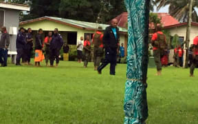 Ratu Epenisa Cakobau escorted by Police and armed military personnel.