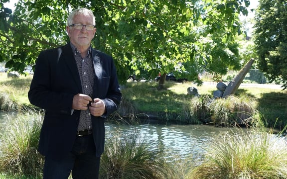Ecan Councillor, Peter Scott, stands by River Avon